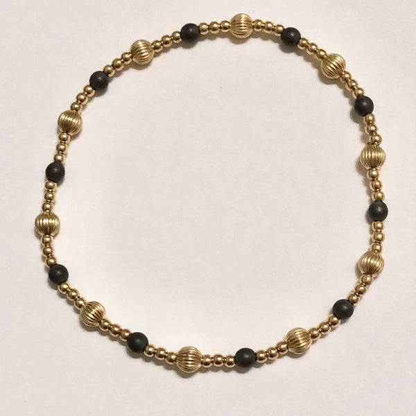gold bracelet with gray and gold beads