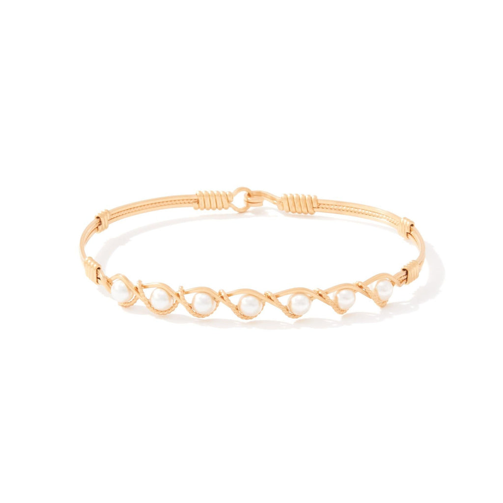Gold bracelet with crystal pearls on a white background