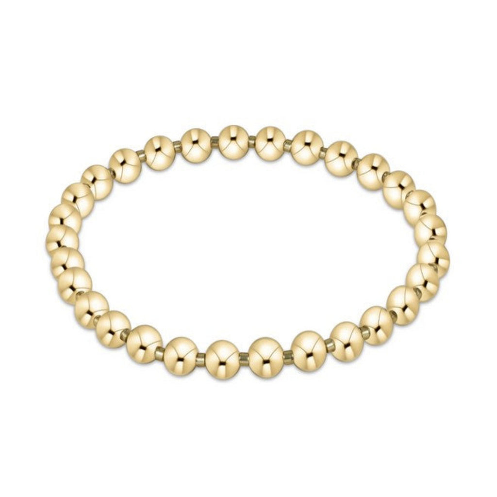 Gold beaded bracelet on a white background