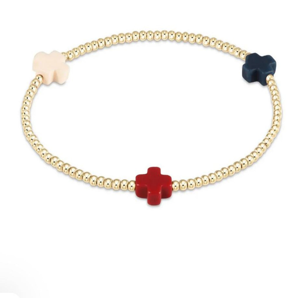Gold beaded bracelet with red, white and blue cross