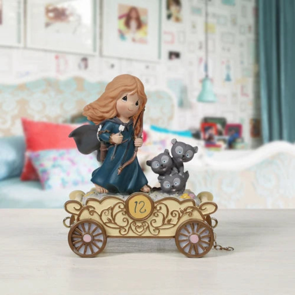 Figurine of a girl with two bears on a decorative car in a room setting
