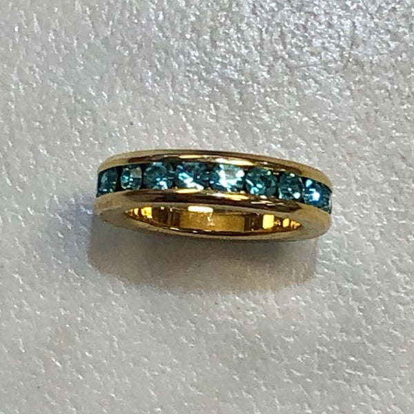 gold circle charm with aquamarine stones
