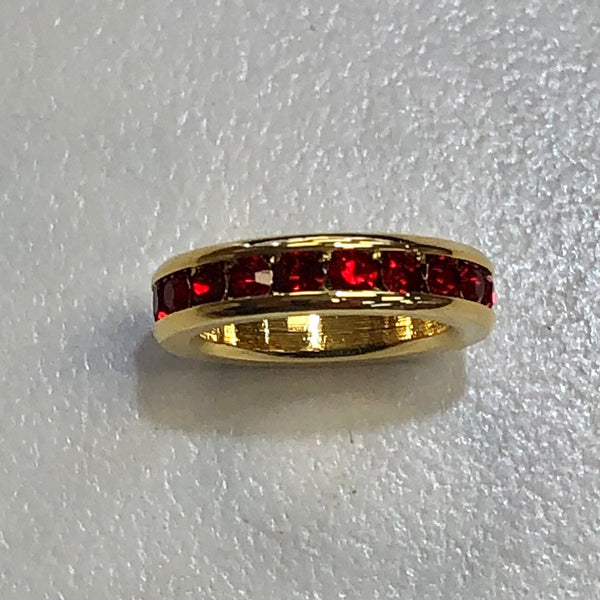 gold circle charm with ruby stones