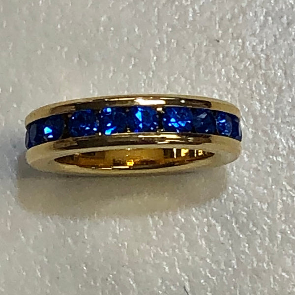 gold circle charm with sapphire stones