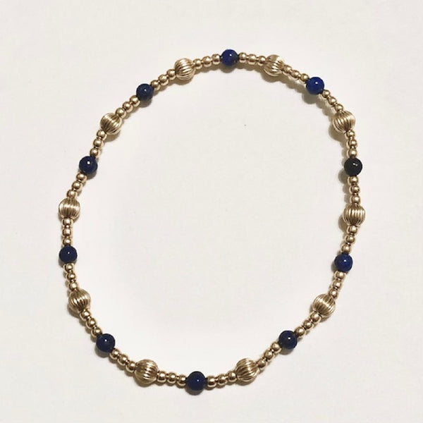 gold bracelet with gold and dark blue beads