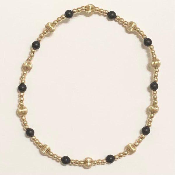 gold bracelet with black and gold beads
