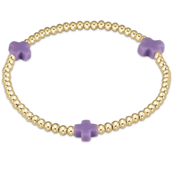 Gold bracelet with 3 purple crosses on a white background