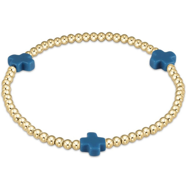 Gold beaded bracelet with 3 blue crosses on a white background
