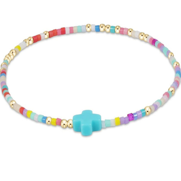 Colorful beaded necklace with a turquoise cross on a white background