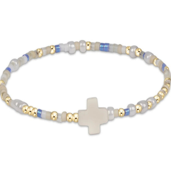 Bracelet with beads and a cross charm on a white background