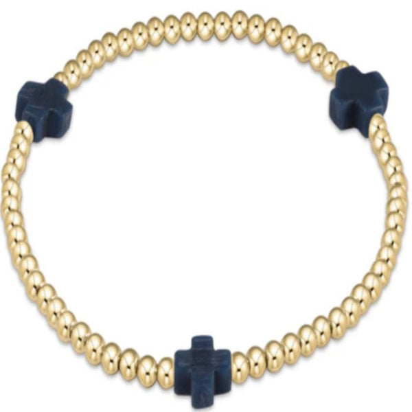 Gold beaded bracelet with 3 navy blue crosses on a white background
