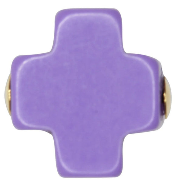 Purple cross-shaped object with gold accents on a white background