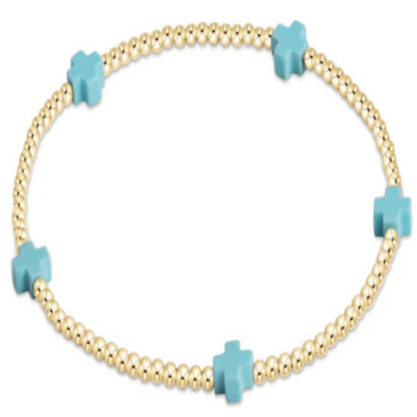 Bracelet with gold beads and turquoise cross charms on a white background
