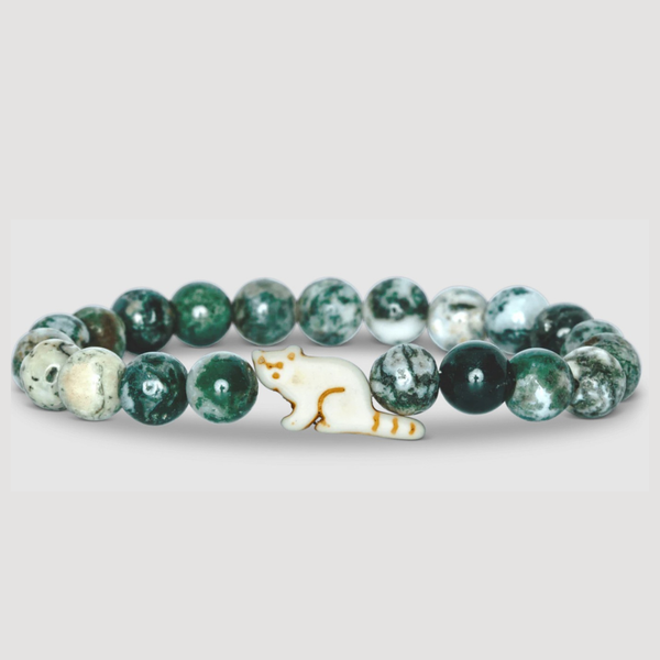 Green beaded bracelet with a red panda shaped charm on a light gray background
