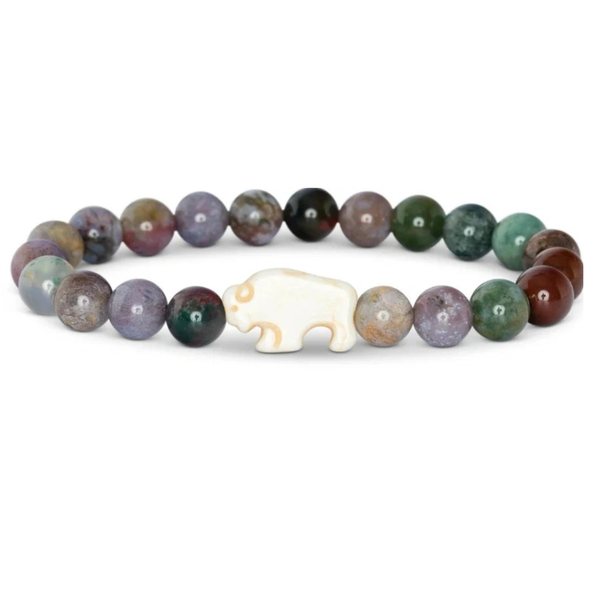 A beaded bracelet featuring polished multicolored gemstone beads and a central carved white animal charm, photographed on a clean white background.