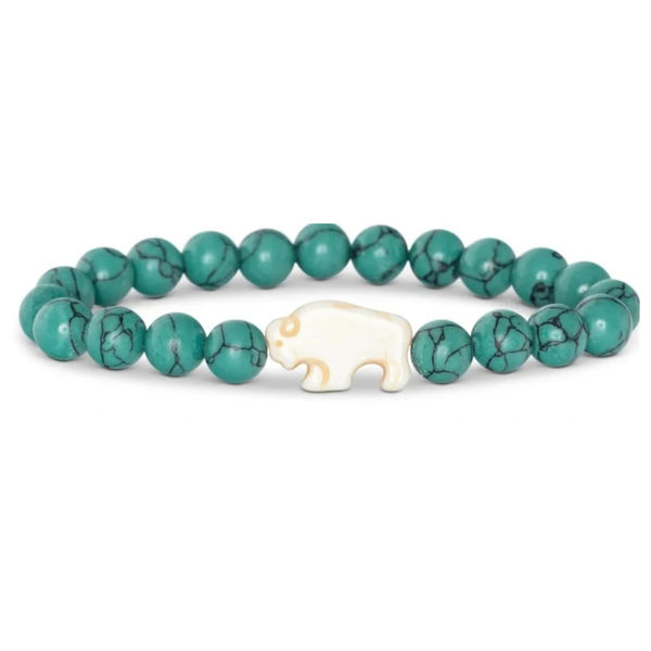 A beaded stretch bracelet featuring round turquoise-green beads with black veining and a small cream-colored carved animal charm in the center, shown on a plain white background.