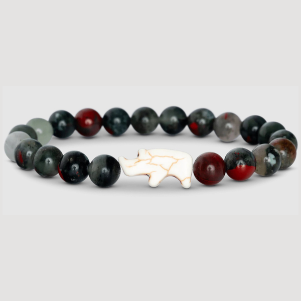 Bracelet with black, red, and gray beads featuring an ivory rhino charm on a light gray background