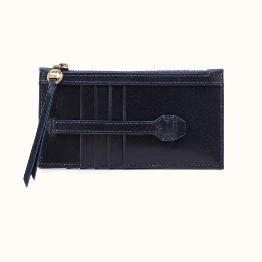 A dark navy blue leather zip-around card holder with a wristlet strap and gold-tone hardware, shown against a plain off-white background.