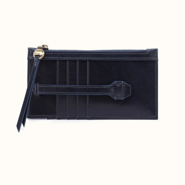 A dark navy blue leather zip-around card holder with a wristlet strap and gold-tone hardware, shown against a plain off-white background.