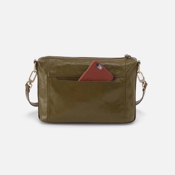 An olive green leather crossbody bag with a front slip pocket containing a red smartphone, shown against a plain light gray background.