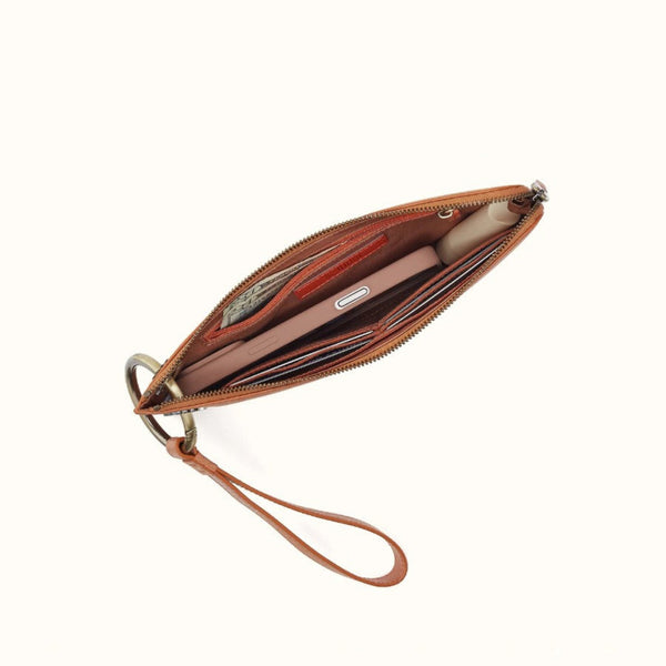 An open brown leather wristlet clutch with multiple card slots, a zip-around closure, and a wrist strap, shown on a plain off-white background.