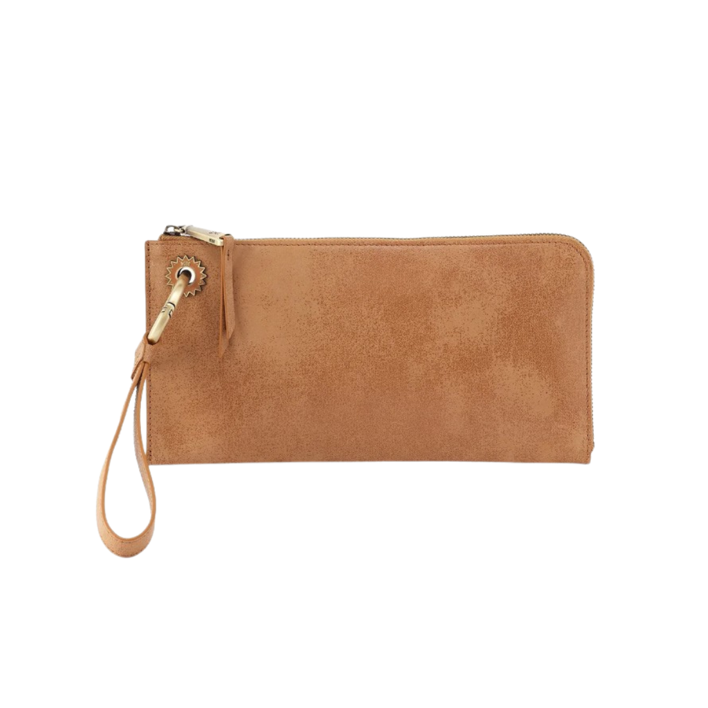 A tan suede zip-around clutch wallet with a matching wristlet strap and gold-tone metal hardware, shown on a plain white background.