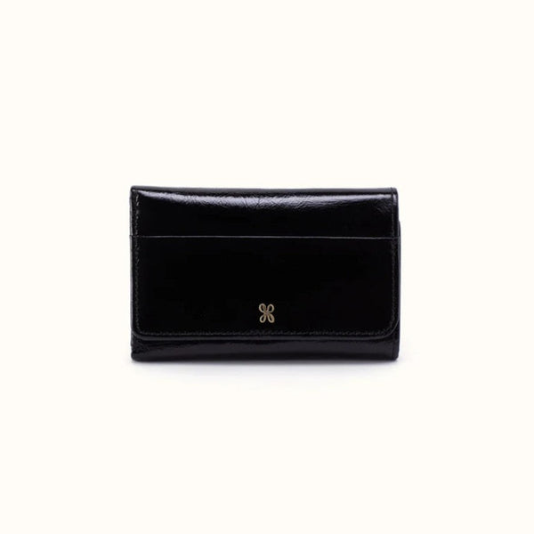A black patent leather bi-fold wallet with a small gold double-X logo on the front, photographed against a plain off-white background.