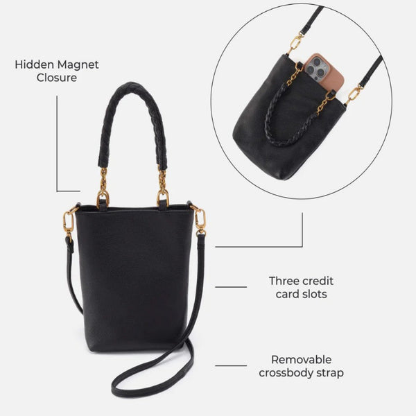 Black leather bucket handbag with gold-tone hardware, braided top handle, detachable crossbody strap, and three card slots, shown on a light gray background with callout labels and a circular inset demonstrating the hidden magnet closure and phone fit.