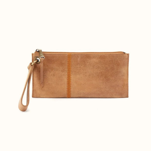 A tan faux-leather zip-around clutch with a wristlet strap and a vertical stitched seam, shown against a plain off-white background.