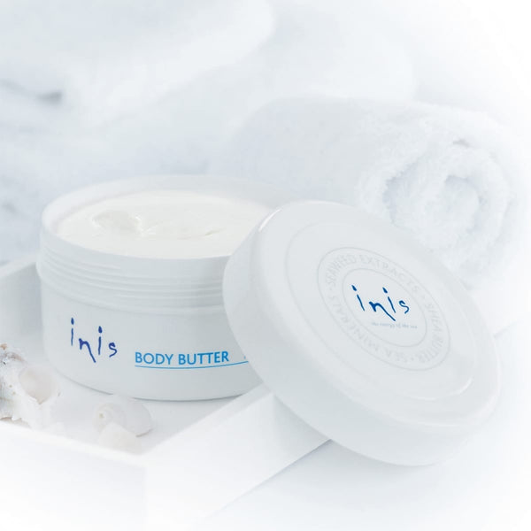Open jar of body butter on white background