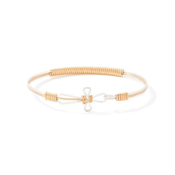 Gold bracelet with a cross design on a white background