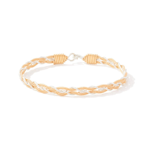 Gold and silver braided bracelet on a white background