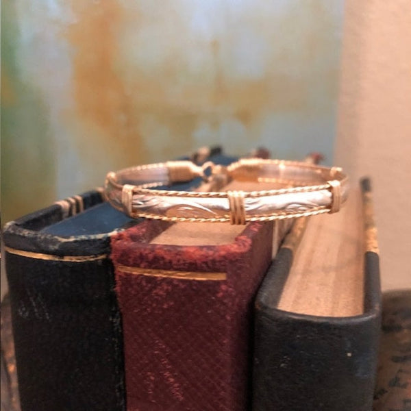 Purpose bracelet sitting on top of books