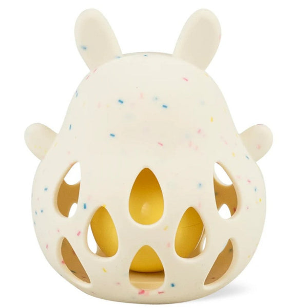 Backsside of hite textured bunny rrattle with ball with colorful specks on a white background