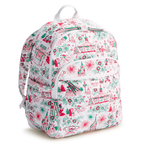 A white backpack featuring a festive Christmas-themed print with red and green illustrations of trees, snowflakes, gingerbread houses, and carousel scenes, shown against a plain white background.