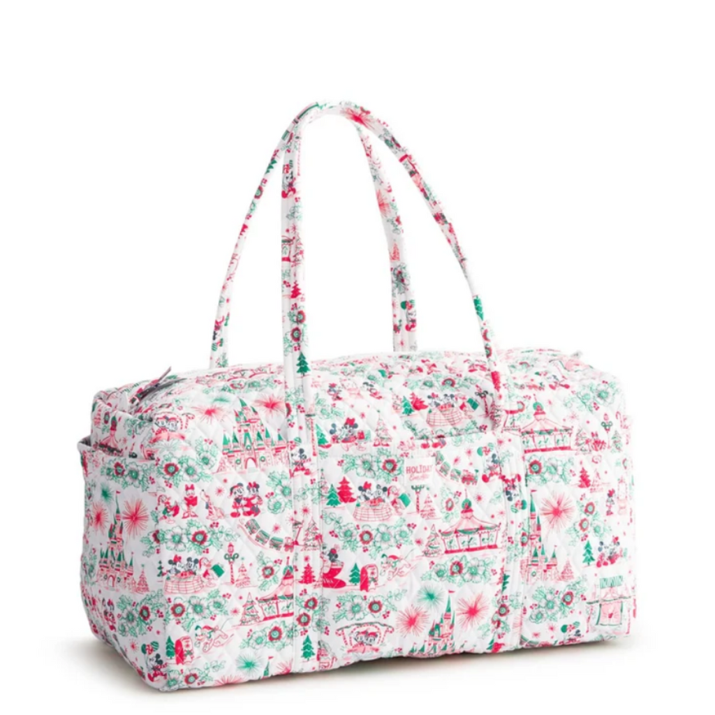 A duffel bag with a white background and a festive Christmas-themed print in red, green, and pink, featuring two top handles and a zippered closure.