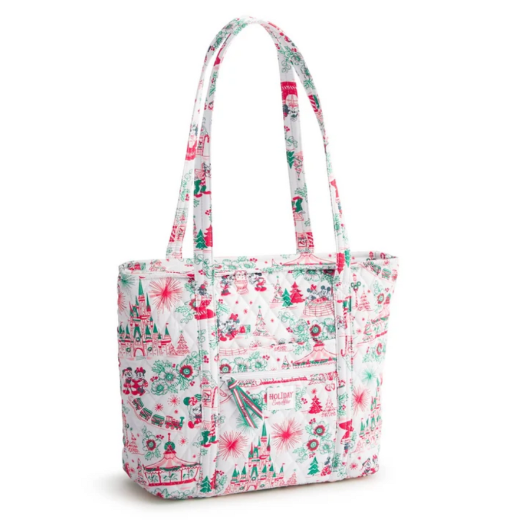 A white fabric tote bag with a festive Christmas print featuring red and green illustrations of trees, ornaments, and snowflakes, shown on a clean white background.