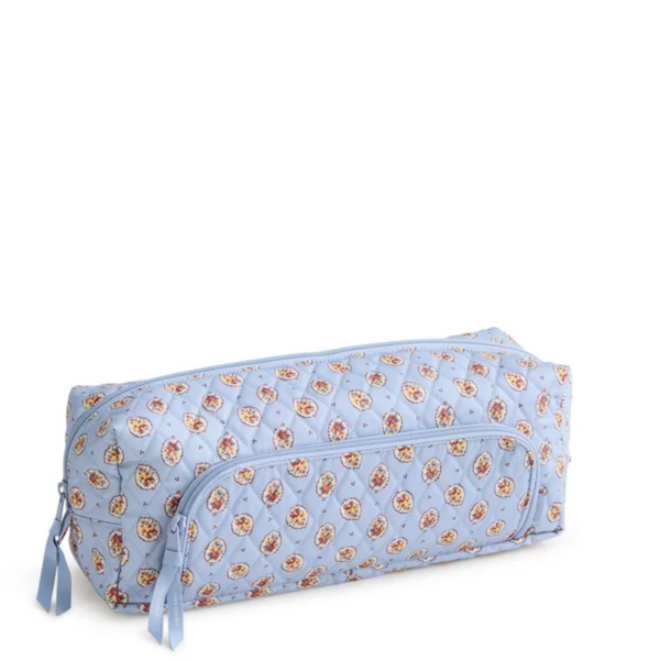 A light blue quilted cosmetic pouch with an all-over small floral print, featuring a front zippered pocket and side zipper pulls, photographed on a white background.