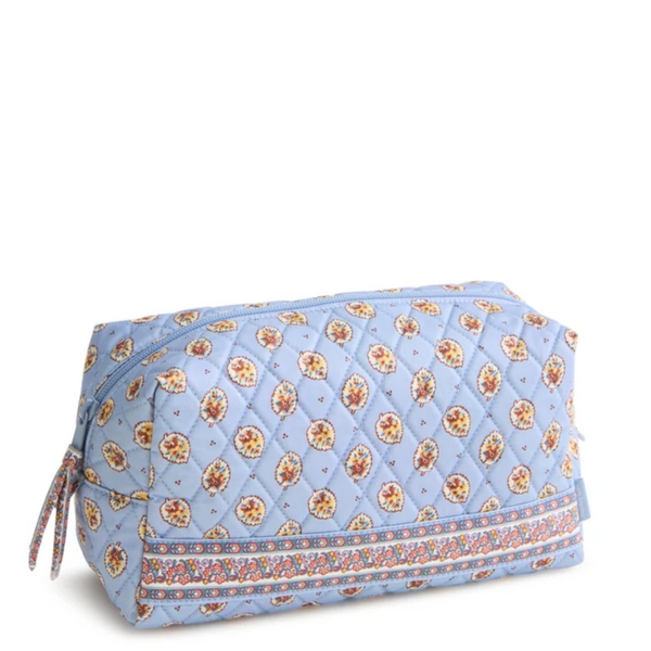 A quilted cosmetic pouch in light blue with a repeating floral pattern and a decorative border, shown on a plain white background.
