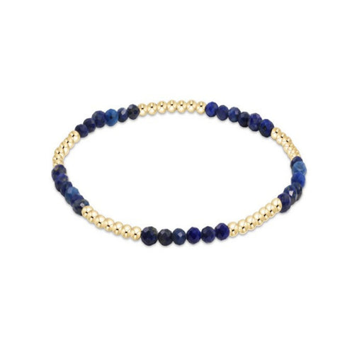 Bracelet with blue beads and gold accents on a white background