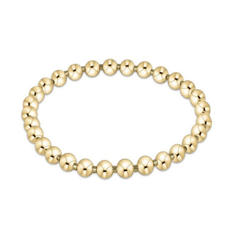 Gold beaded bracelet on a white background