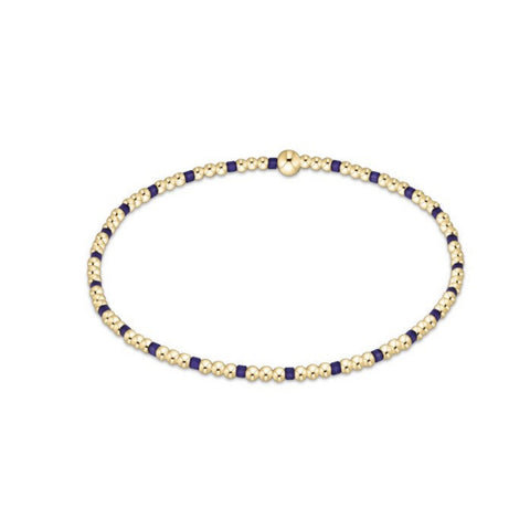 Gold and purple beaded necklace on a white background