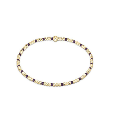 Gold and purple beaded bracelet on a white background