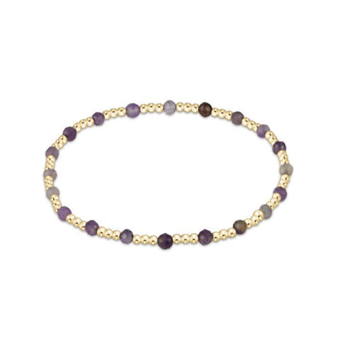 Bracelet with gold and amethyst stone on a white background