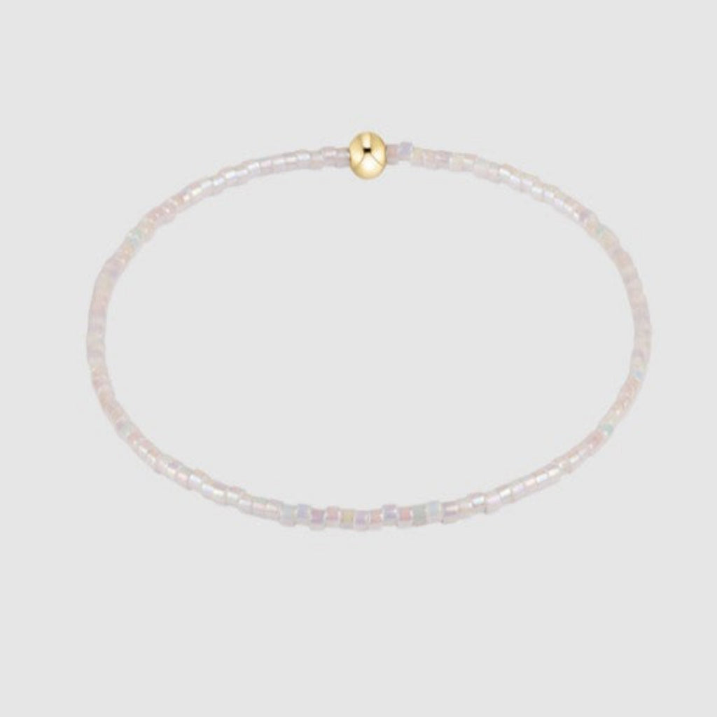 White Beaded Bracelet on Gray Background