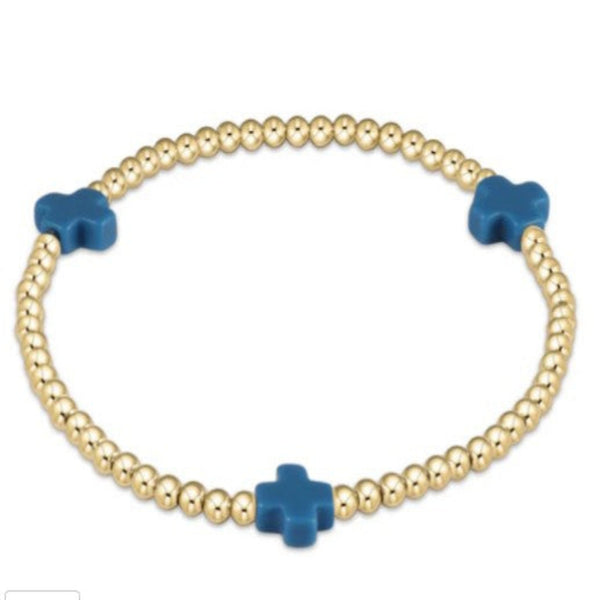 Gold beaded bracelet with 3 blue cross charms on a white background