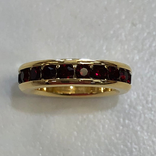 gold circle charm with garnet stones