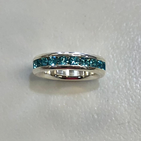 silver circle charm with aquamarine stones